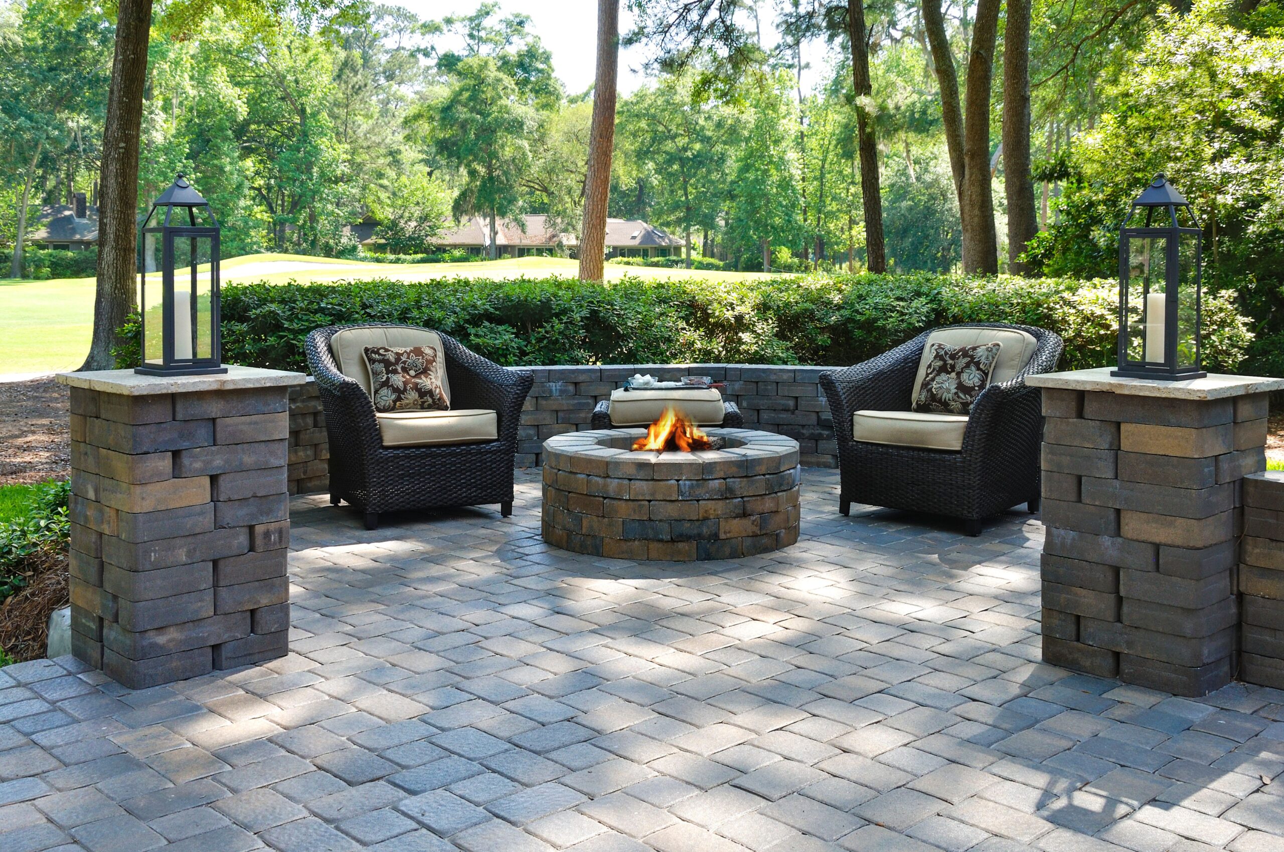 Stone paver patio with a firepit and two chairs