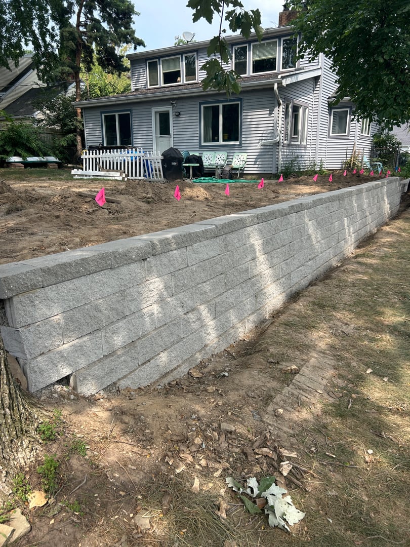 Retaining wall along the property line of a residential yard