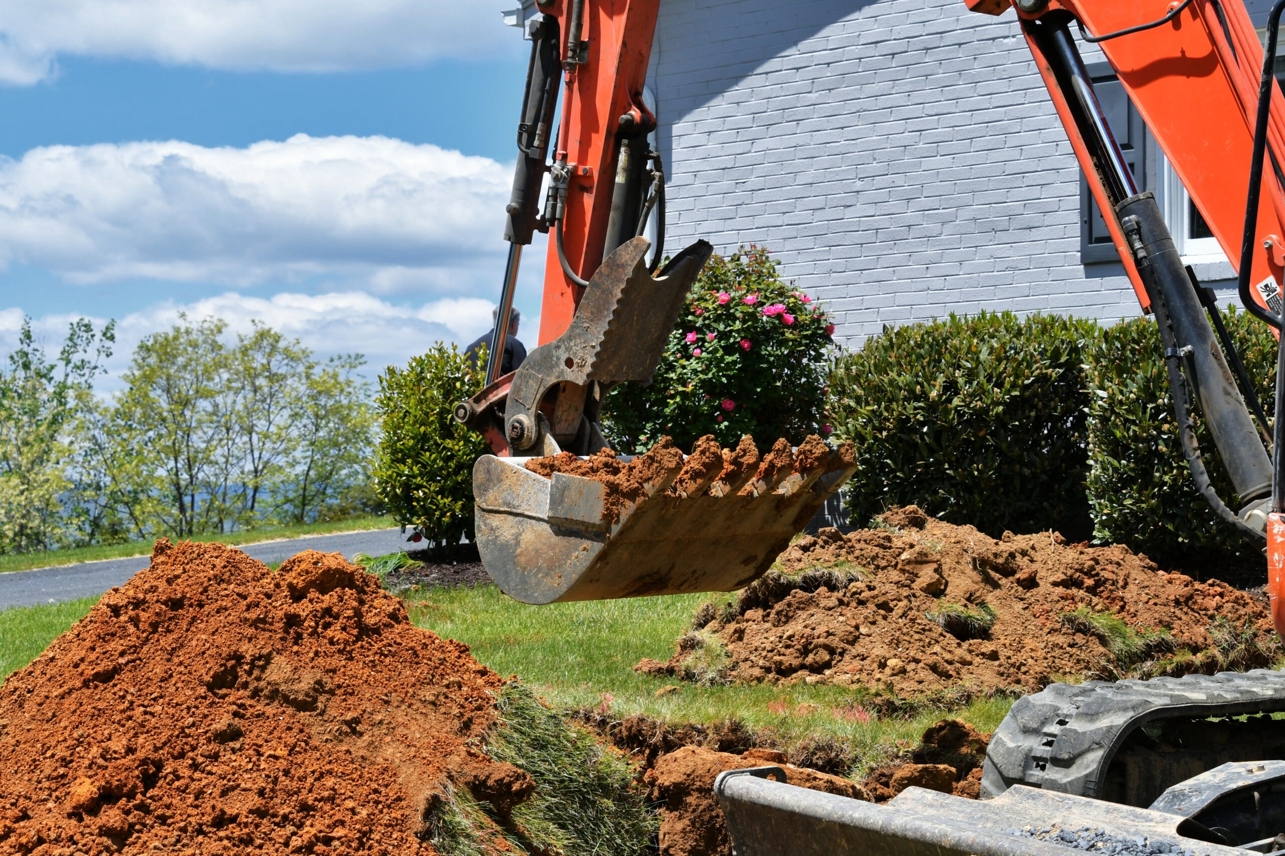 Excavator digging for a landscaping project