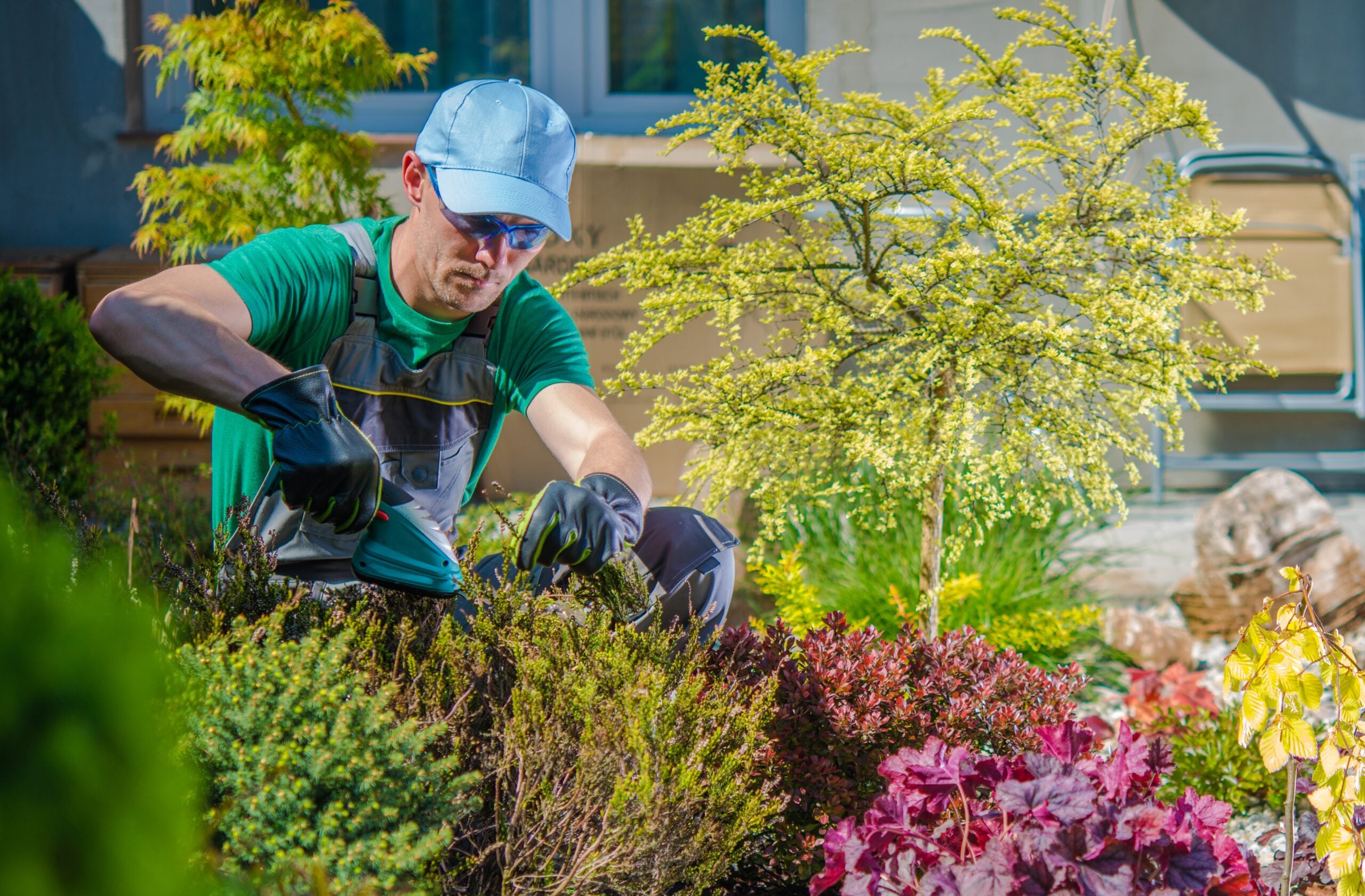 Gardener tending to a garden bed.